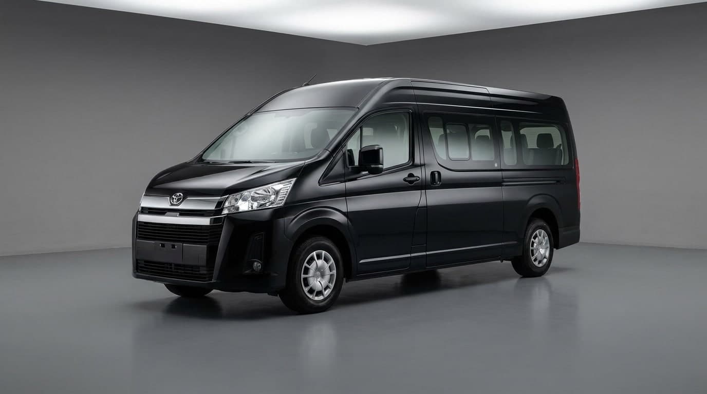 White minibus parked on a sunny beachside boulevard lined with pines